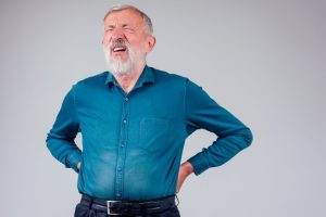 sick senior old man suffering face expression spine ache pain studio white background