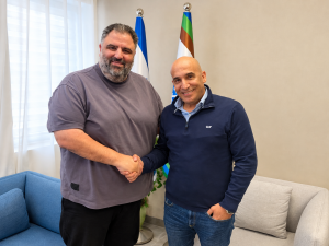 Friendly Office Handshake by the Flags