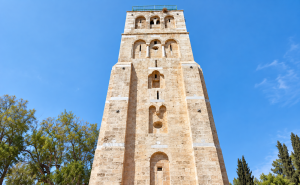 Historic Limestone Tower Against Blue Sky