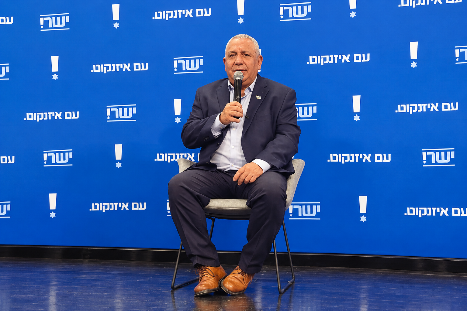 Man Speaking on a Blue Campaign Stage