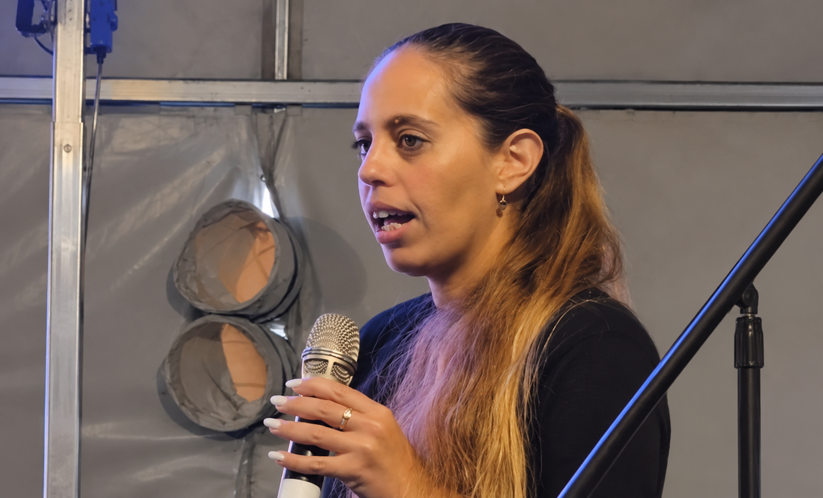 Profile Speaker Under a Gray Tent