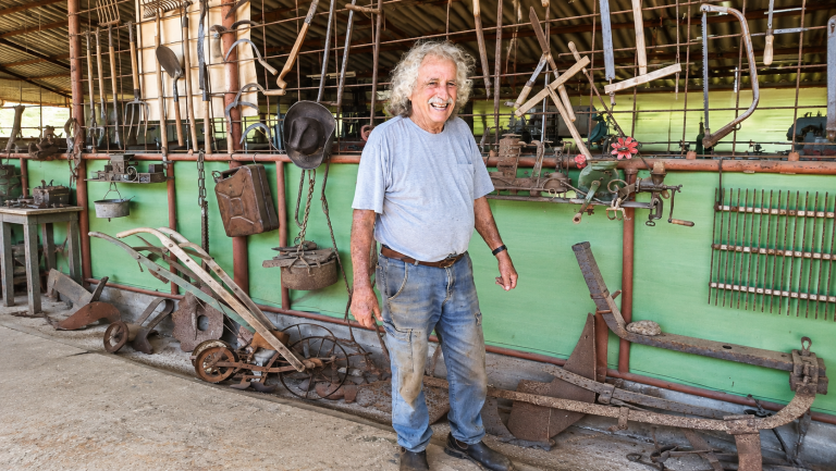 Smiling Farmer in a Vintage Tool Shed